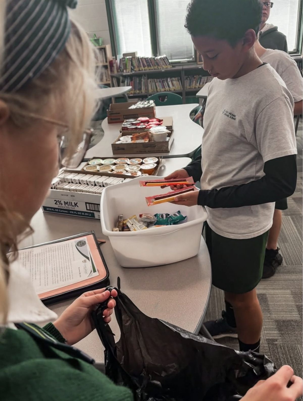 Community Service Club students assembling snack bags